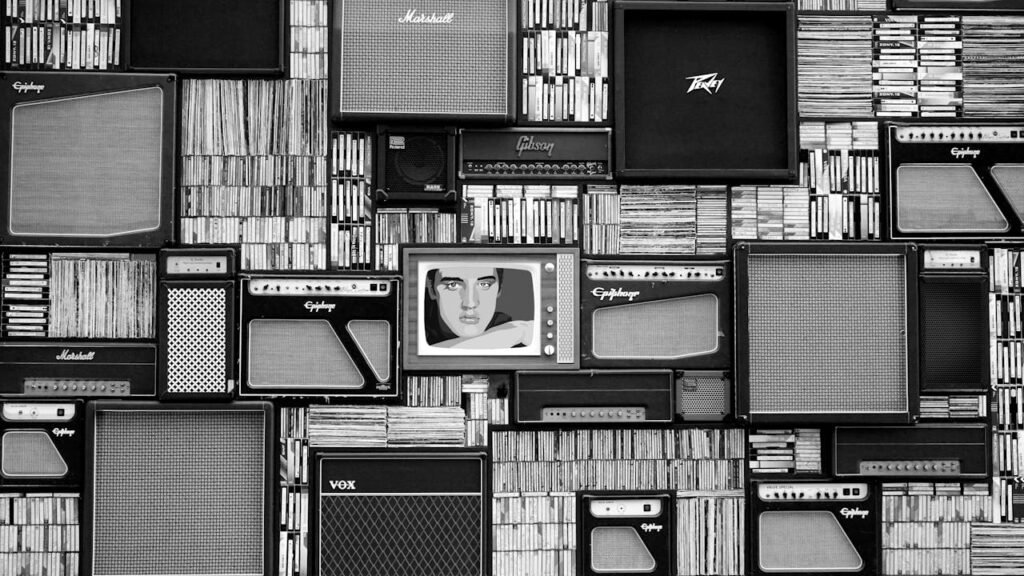 pexels-photo-114820 Vintage amplifiers and vinyl records arranged in a striking black and white pattern.