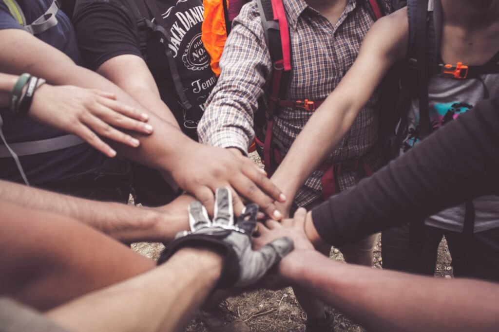 pexels-photo-3280130 A group of diverse individuals join hands for teamwork in West Java, Indonesia.